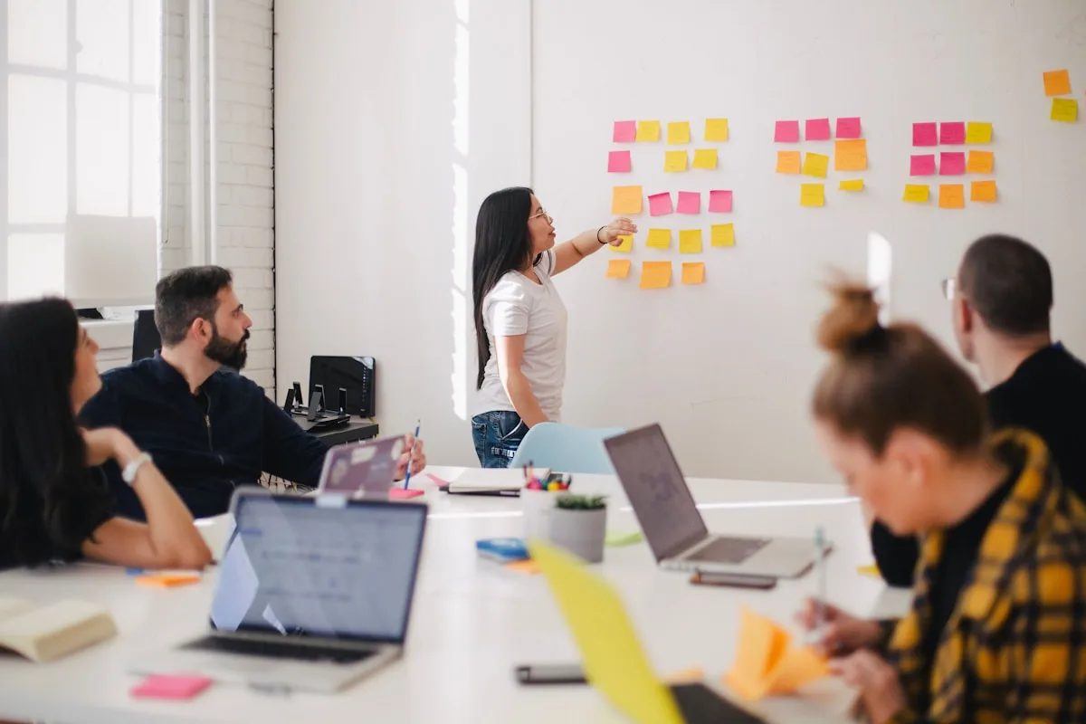 Team planning digital product roadmap around a workshop board
