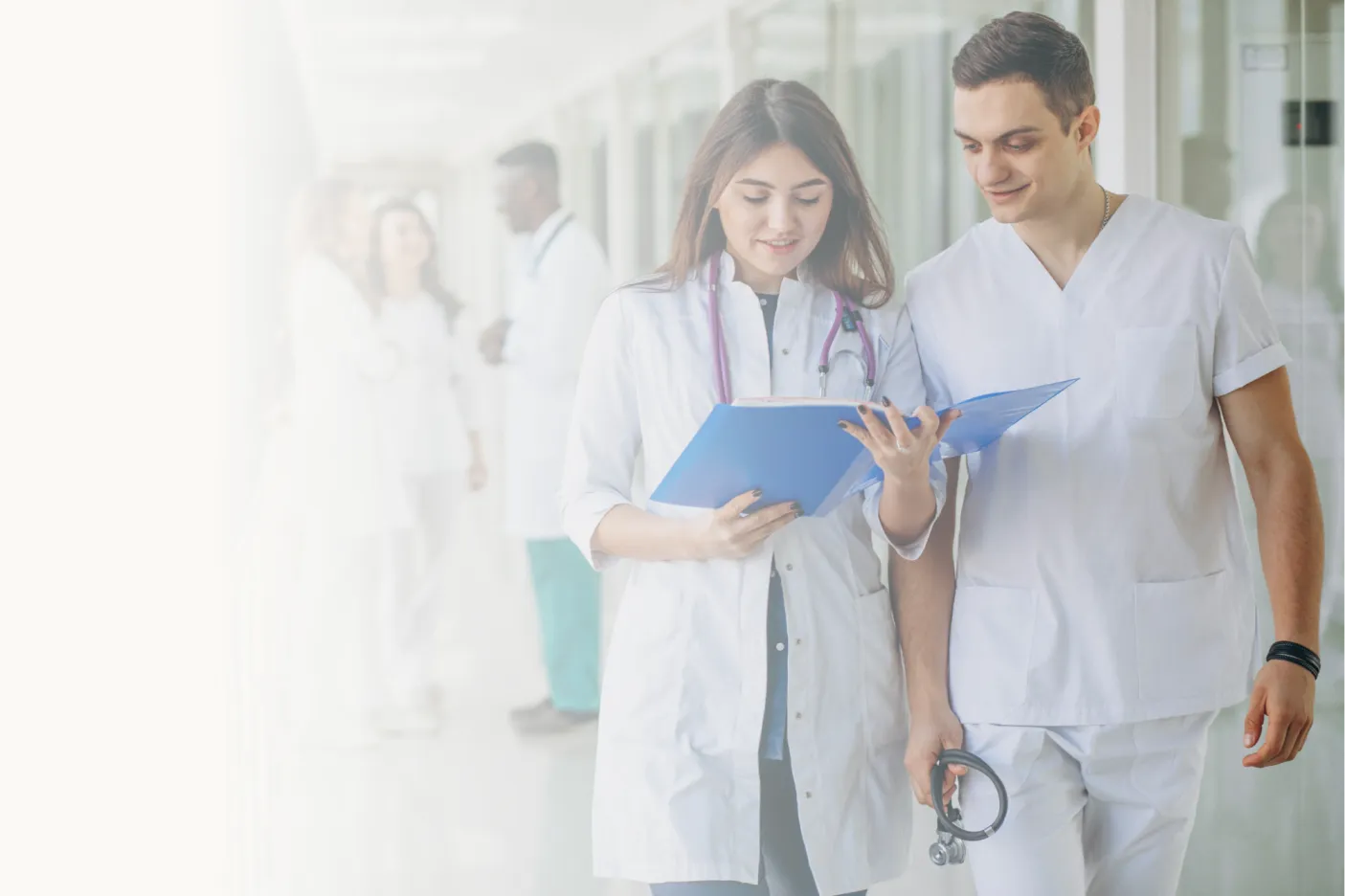 Two healthcare professionals review a document in a hospital.
