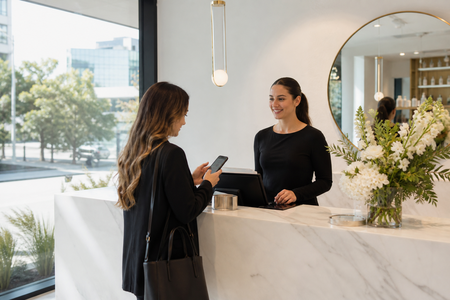 Bright Auckland salon reception with a customer booking an appointment on a phone