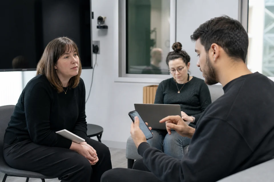 UX researcher running a mobile app usability test with a participant