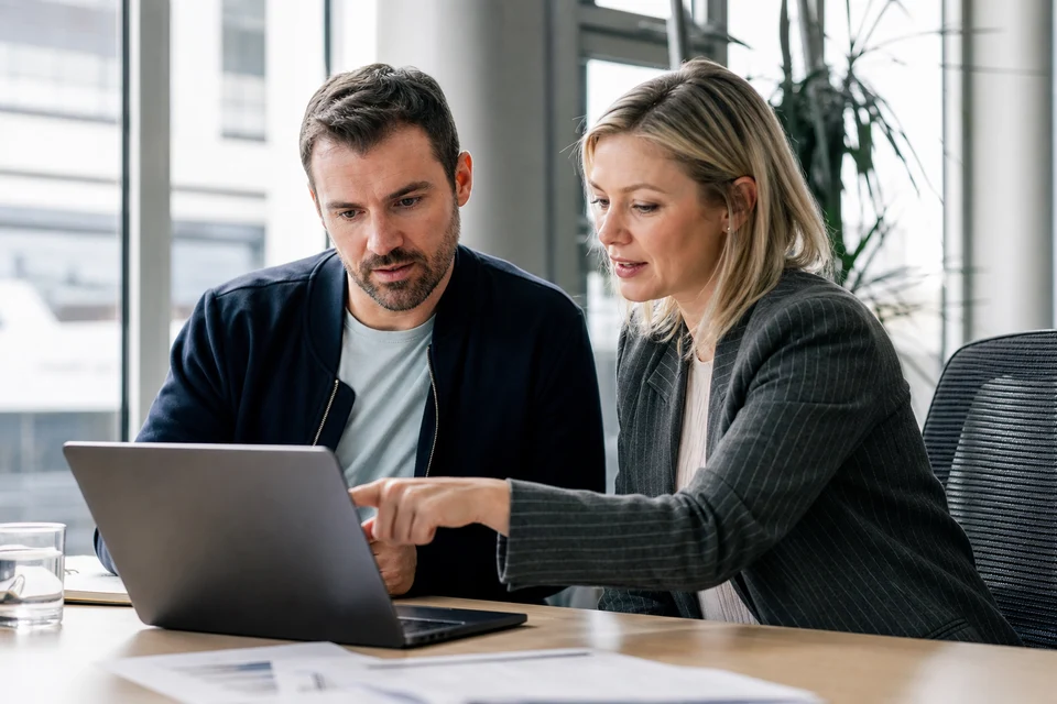 UK business owner and recruiter reviewing a mobile developer hiring budget and contract