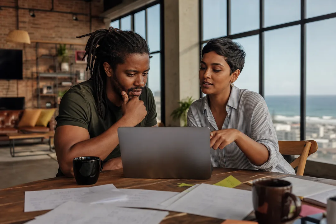 Founder and consultant reviewing a music streaming app development budget in South African Rand